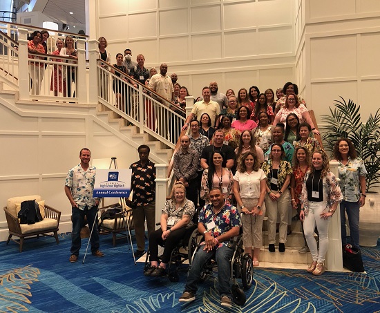 Big group of people associated with the Able Trust on a staircase.