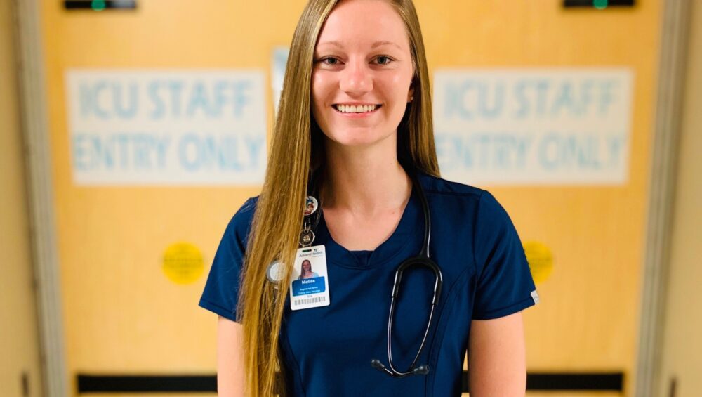 Headshot of young woman in nursing scrubs.